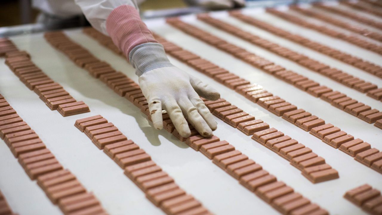 A Japanese worker checks strawberry flavor Kit Kat bars in 2017.