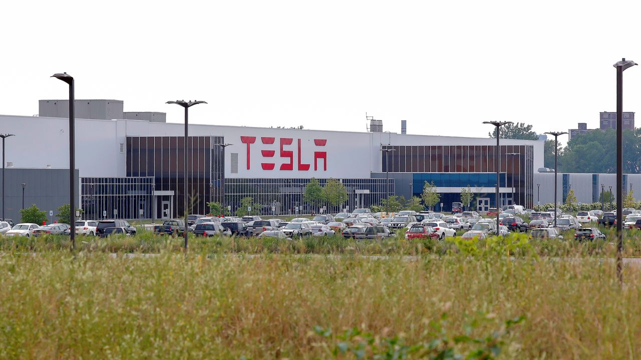 Cars are parked outside the Tesla Inc. Gigafactory 2, which is also known as RiverBend, a joint venture with Panasonic to produce solar panels and roof tiles in Buffalo, New York, U.S., August 3, 2018. 