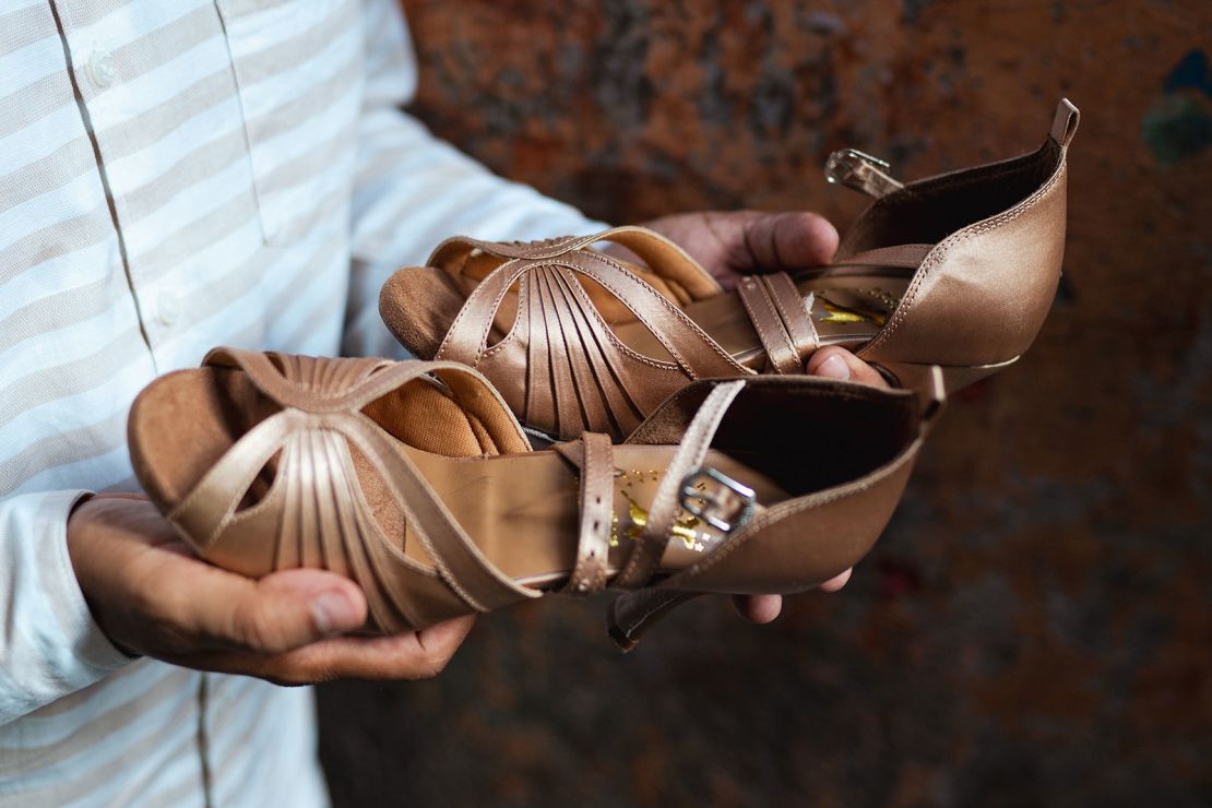 Shah shows the finished shoes produced at his workshop in Mumbai on April 14, 2024.